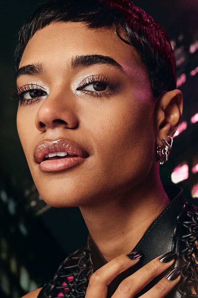 Model wearing Maybelline Lash Sensational Firework mascara showing bold, lifted lashes with shimmery eyeshadow look.