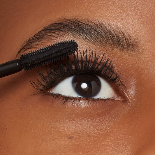 Close-up of Maybelline Lash Sensational Firework Washable mascara being applied with SuperSpark brush on upper lashes.