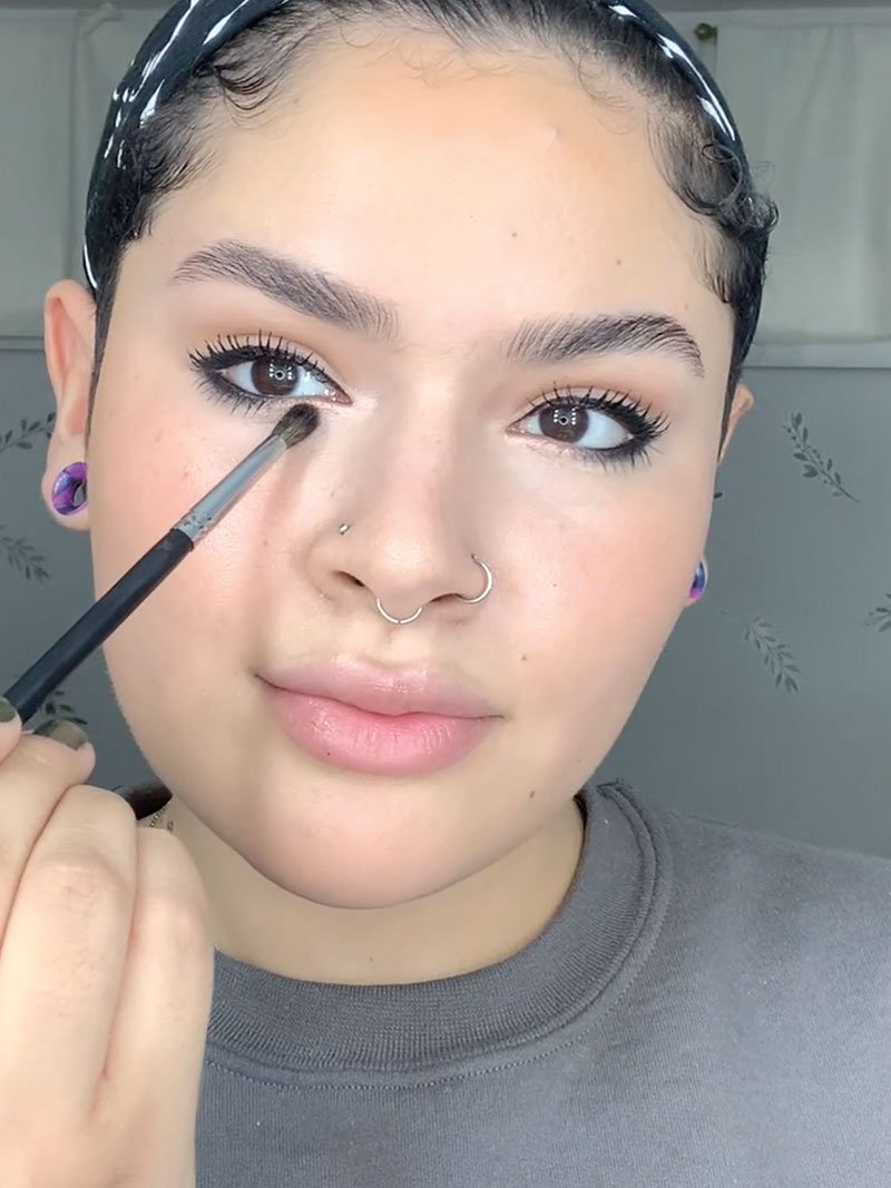 Karol brightens the inner eye area with shimmer eyeshadow by Maybelline.
