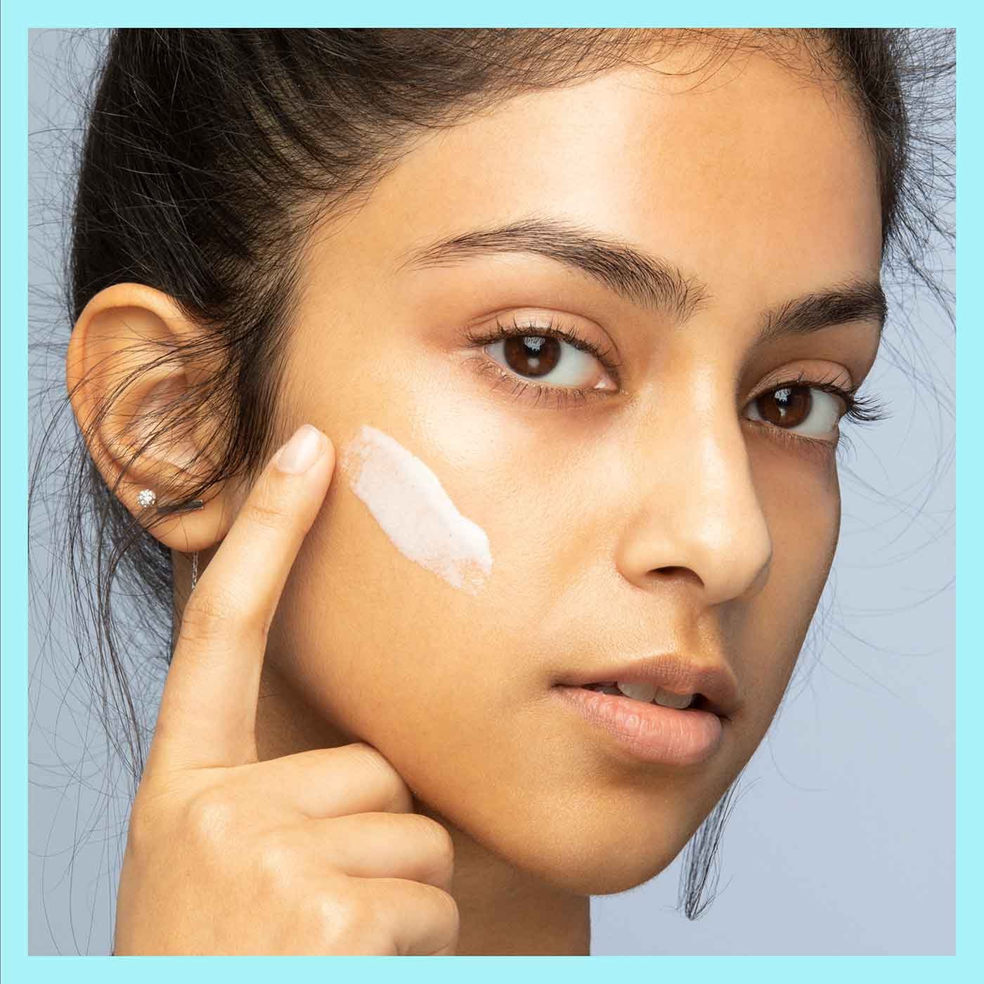 Model applying Fit Me Mattifying Primer by Maybelline.