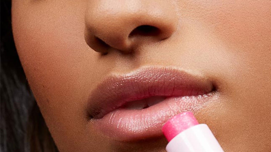 Maybelline's Baby Lip Gloss in Pink Punch featured against model's lips