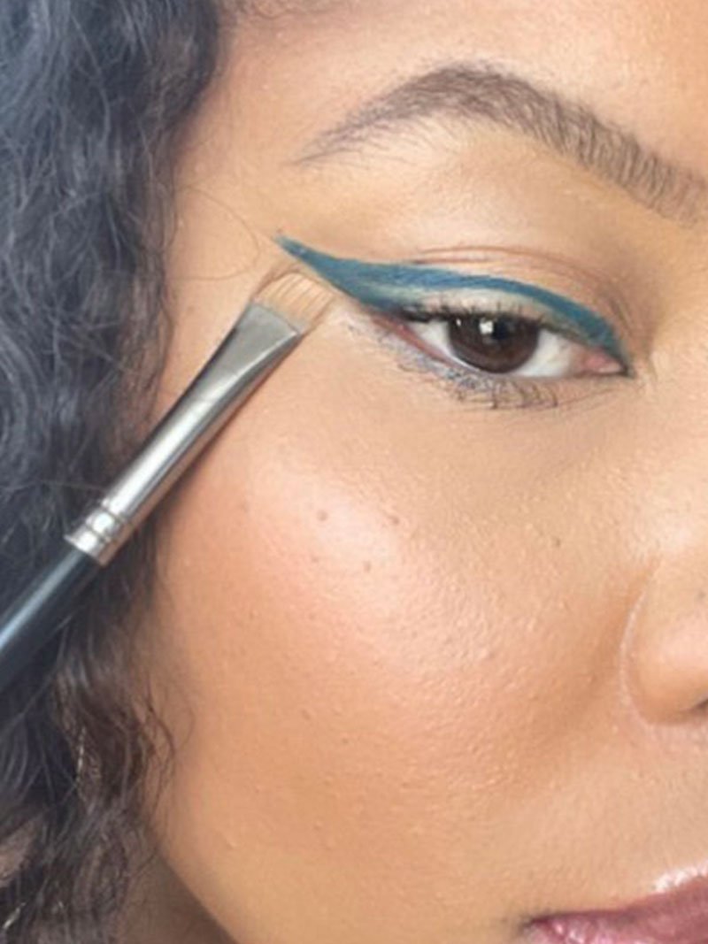 Makeup artist Brandy Allen applies blue eyeliner by Maybelline to create a blue makeup look.